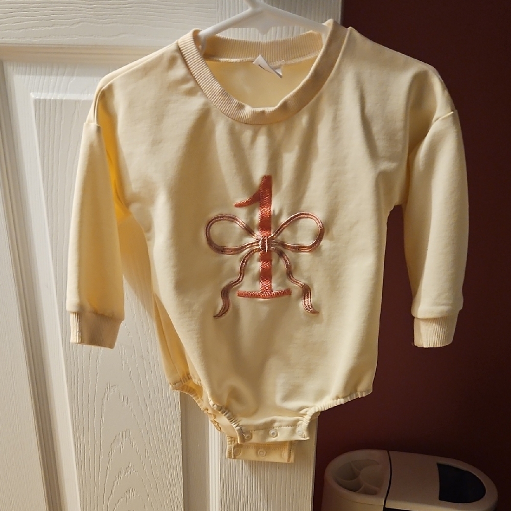 Cream Long Sleeve Baby Onesie with Pink Bow Design